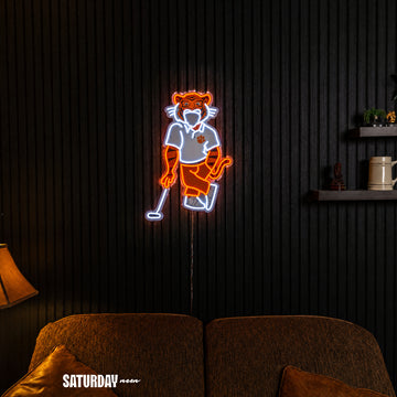Clemson Tigers Swinging Tiger Golf Mascot LED Neon Sign - 17.54" x 24" in a living room - Saturday Neon
