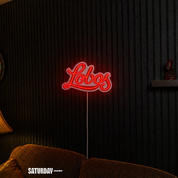 New Mexico Lobos Script LED Neon Sign - Standard (15" x 8.96") above a couch - Saturday Neon