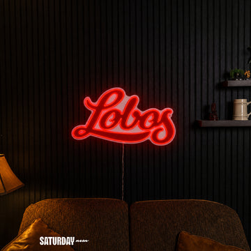 New Mexico Lobos Script LED Neon Sign - Plus (24" x 14.27") in a living room - Saturday Neon