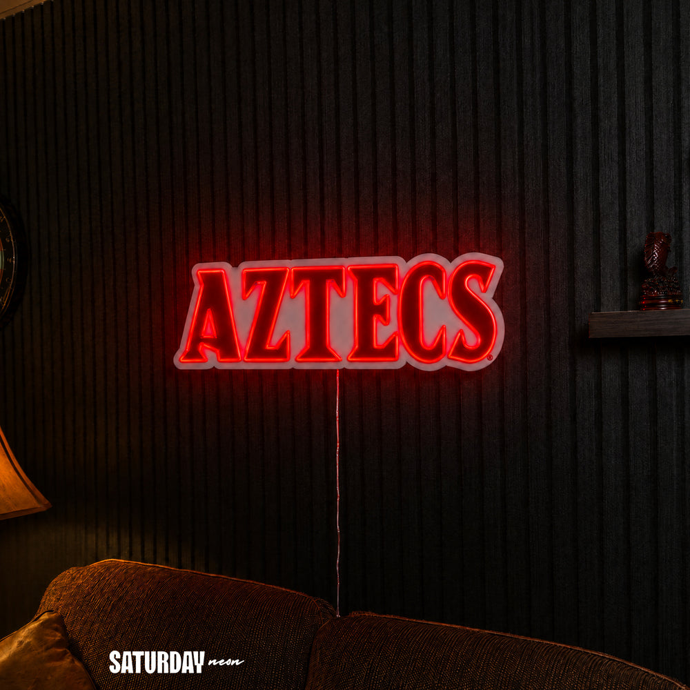 San Diego State Aztecs Wordmark LED Neon Sign - 24" x 8.11" above a couch - Saturday Neon