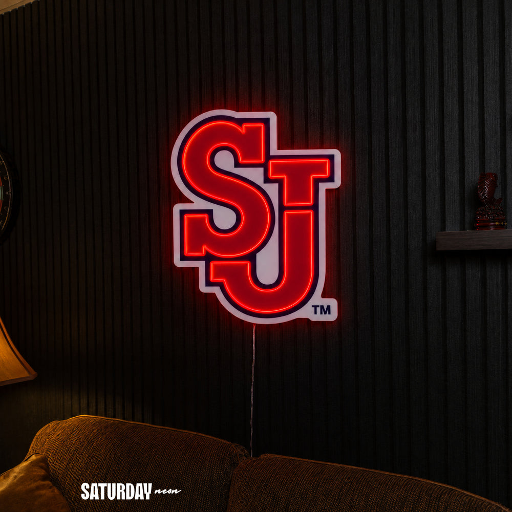 St. John's Red Storm SJ LED Neon Sign - Max (23.38" x 32") above a couch - Saturday Neon