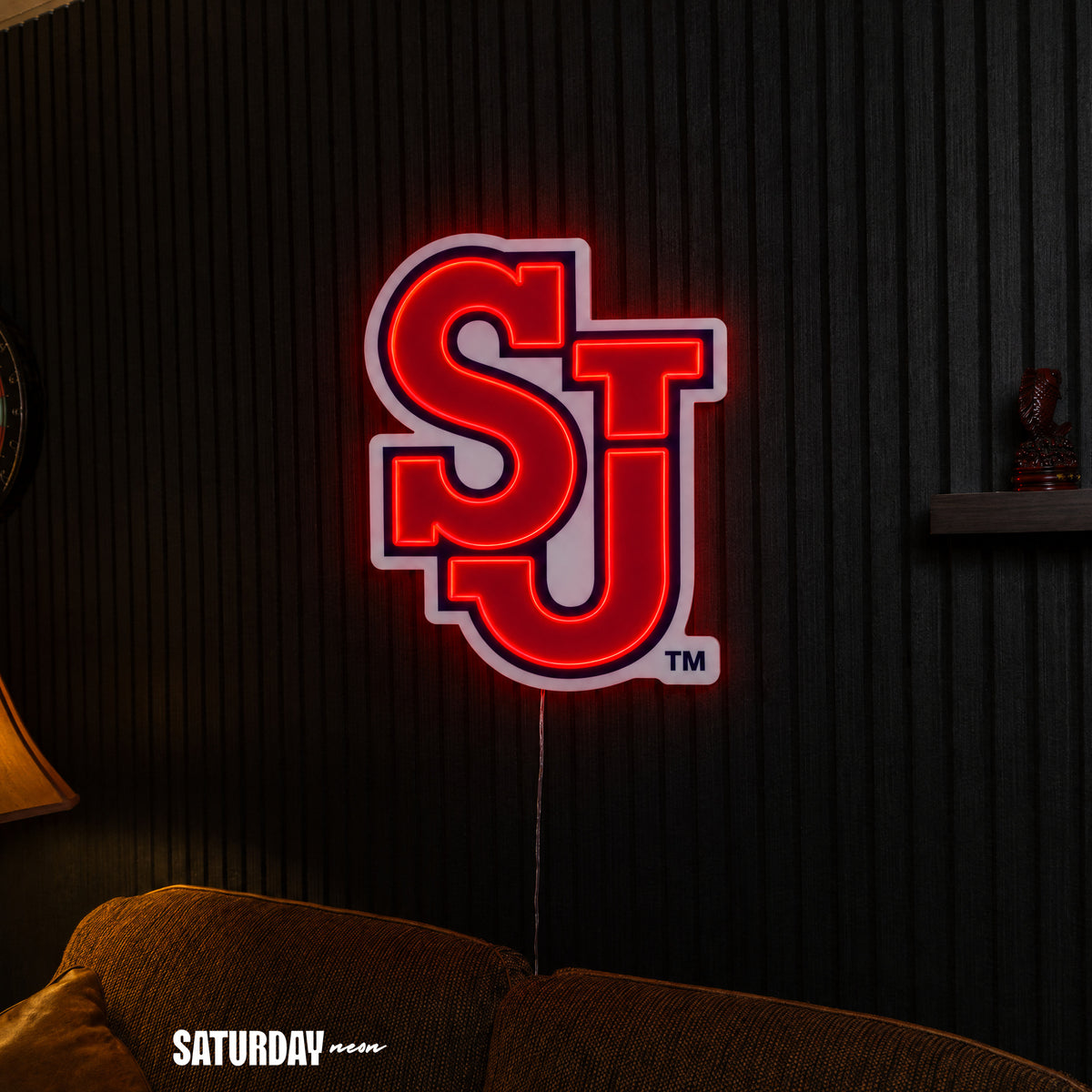 St. John's Red Storm SJ LED Neon Sign - Max (23.38" x 32") above a couch - Saturday Neon