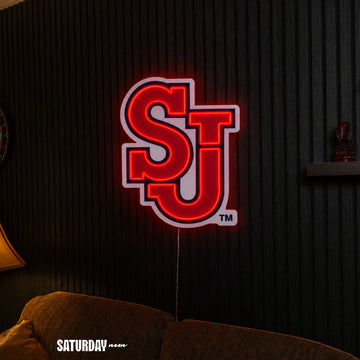 St. John's Red Storm SJ LED Neon Sign - Max (23.38" x 32") above a couch - Saturday Neon