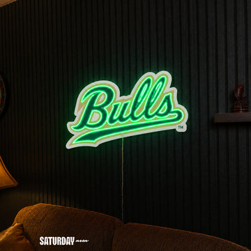 USF Bulls Script LED Neon Sign - 24" x 14.55" above a couch - Saturday Neon
