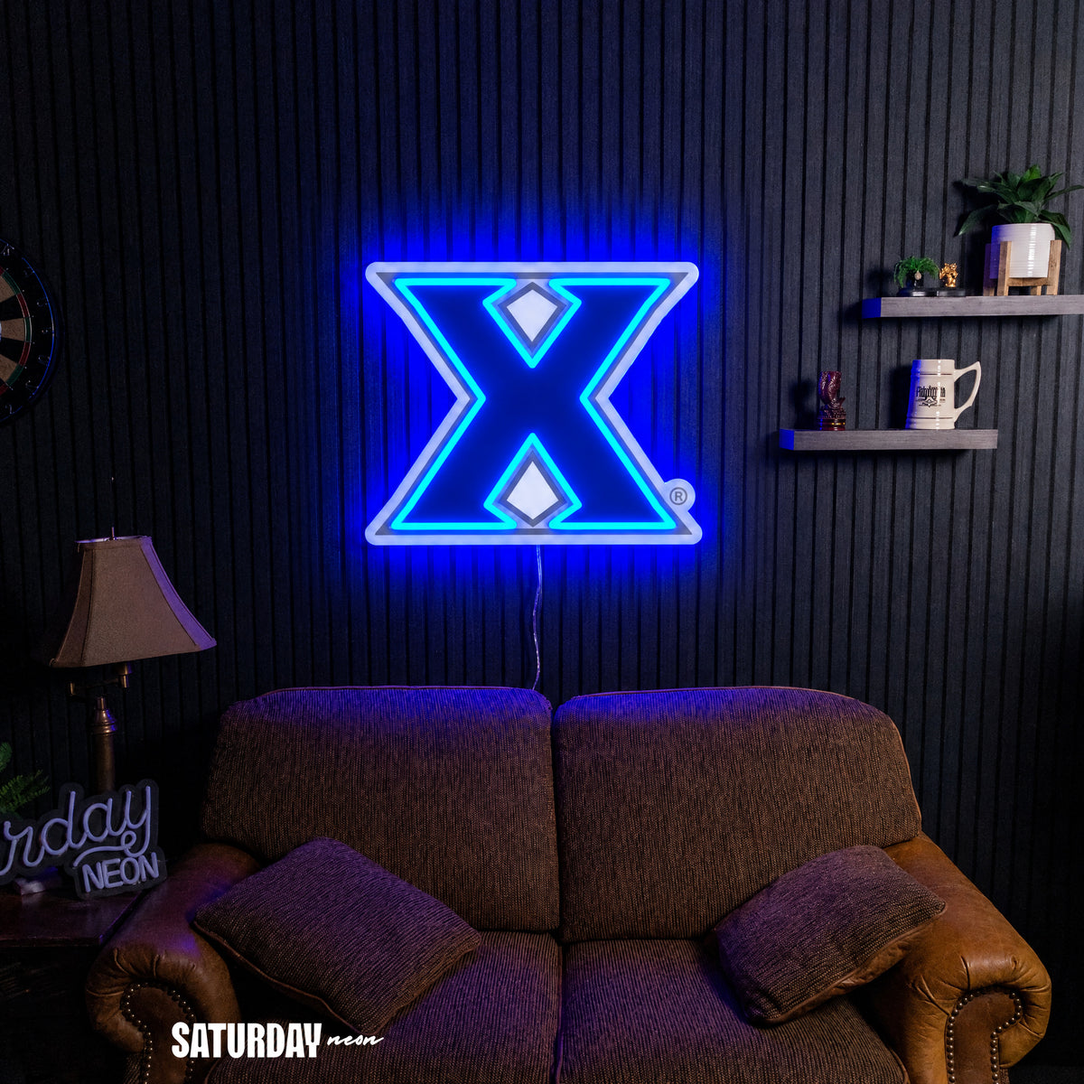 Xavier Musketeers X Primary Mark LED Neon Sign - Max (32" x 25.89") above a couch - Saturday Neon