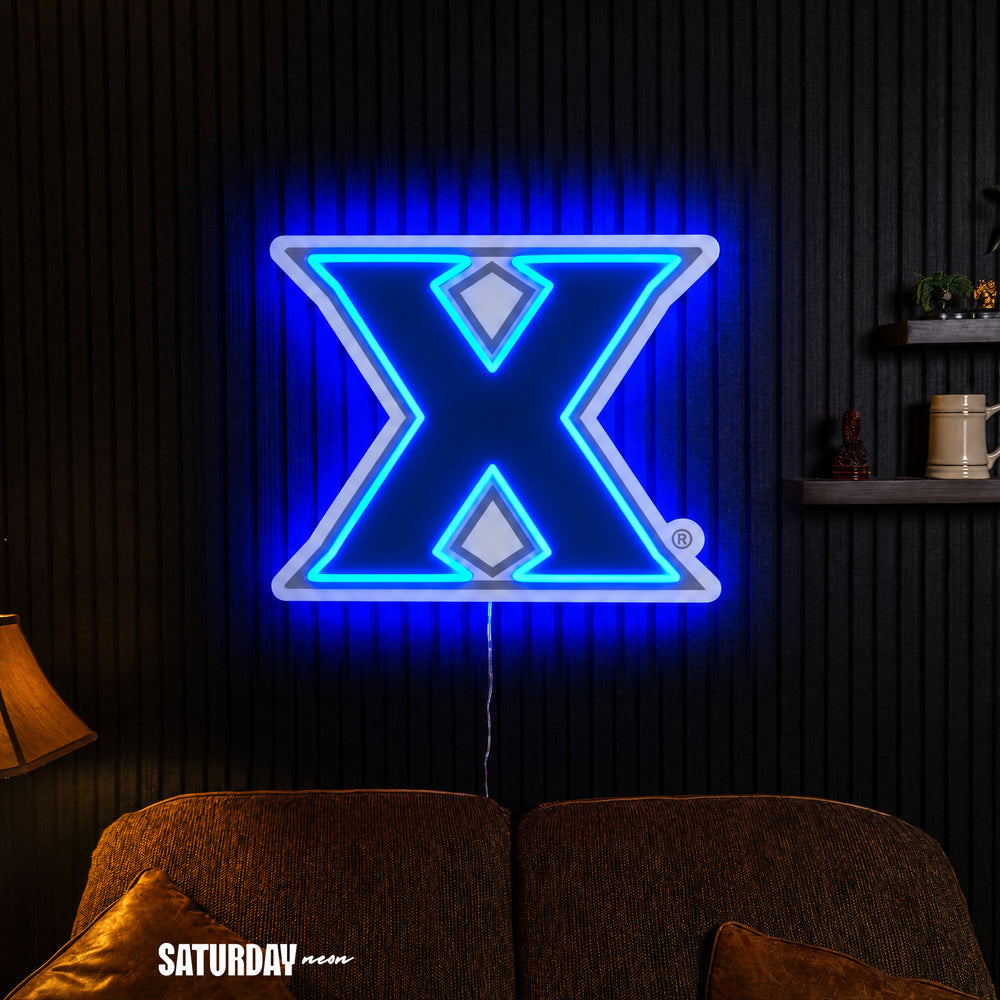 Xavier Musketeers X Primary Mark LED Neon Sign - Max (32" x 25.89") in a living room - Saturday Neon