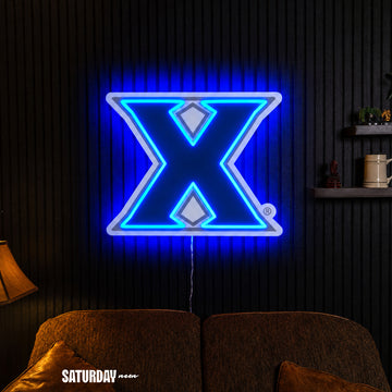 Xavier Musketeers X Primary Mark LED Neon Sign - Max (32" x 25.89") in a living room - Saturday Neon
